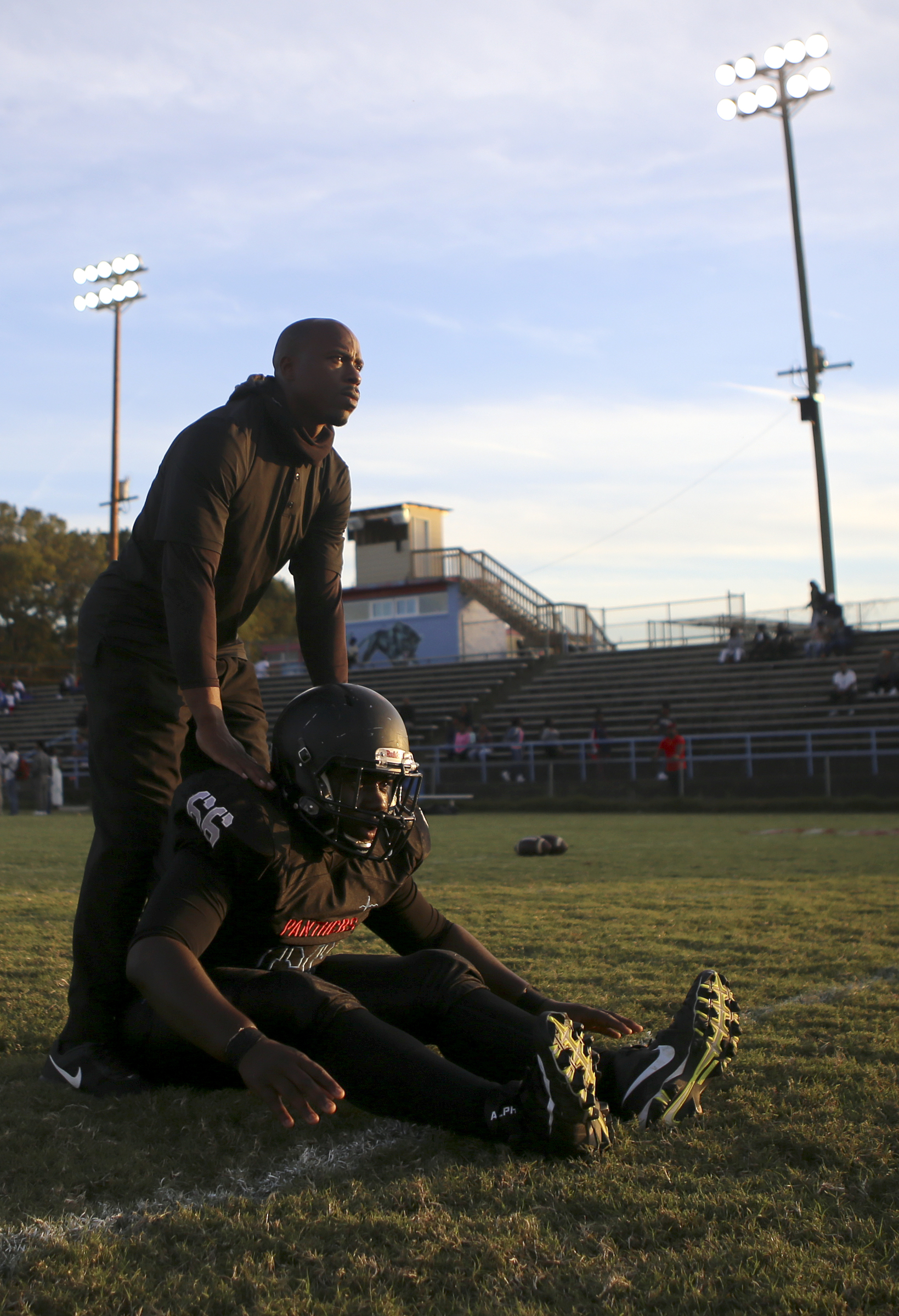 Brainerd head coach Tyrus Ward helps Kobe Goines stretch out before kickoff against Tyner at Brainerd High School on Friday, Oct. 20, in Chattanooga, Tenn.
