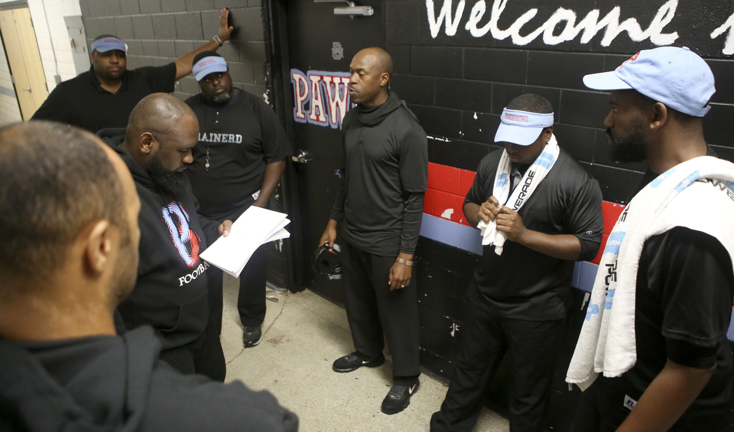Brainerd head coach Tyrus Ward, center, meets with his coaches during halftime of their game against Tyner outside of the locker room at Brainerd High School on Friday, Oct. 20, in Chattanooga, Tenn.
