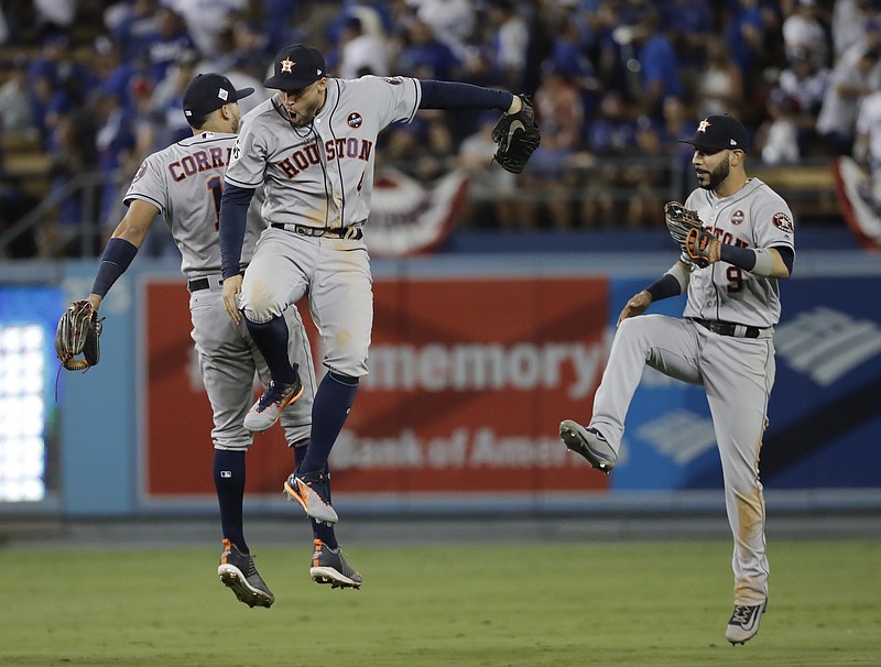 Houston Astros' Carlos Correa, George Springer one Marwin Gonzalez celebrate after Game 2 of baseball's World Series against the Los Angeles Dodgers Wednesday, Oct. 25, 2017, in Los Angeles. The Astros won 7-6 to tie the series at 1-1. (AP Photo/David J. Phillip)