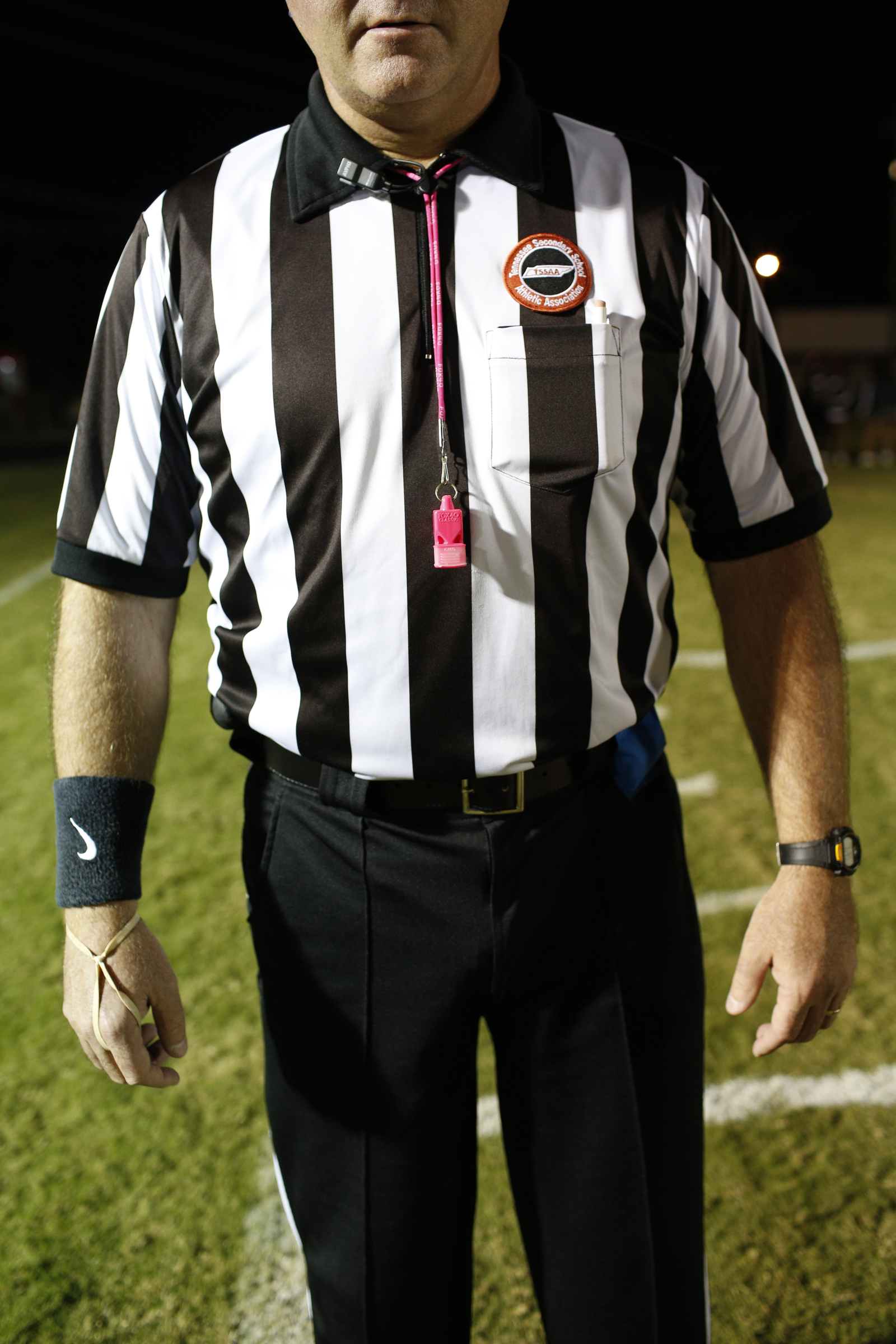 Officials wear pink ribbons in honor of a relative of the team whose family member had breast cancer during Tyner and Central's prep football game at Tyner High School on Friday, Oct. 27, 2017, in Chattanooga, Tenn.