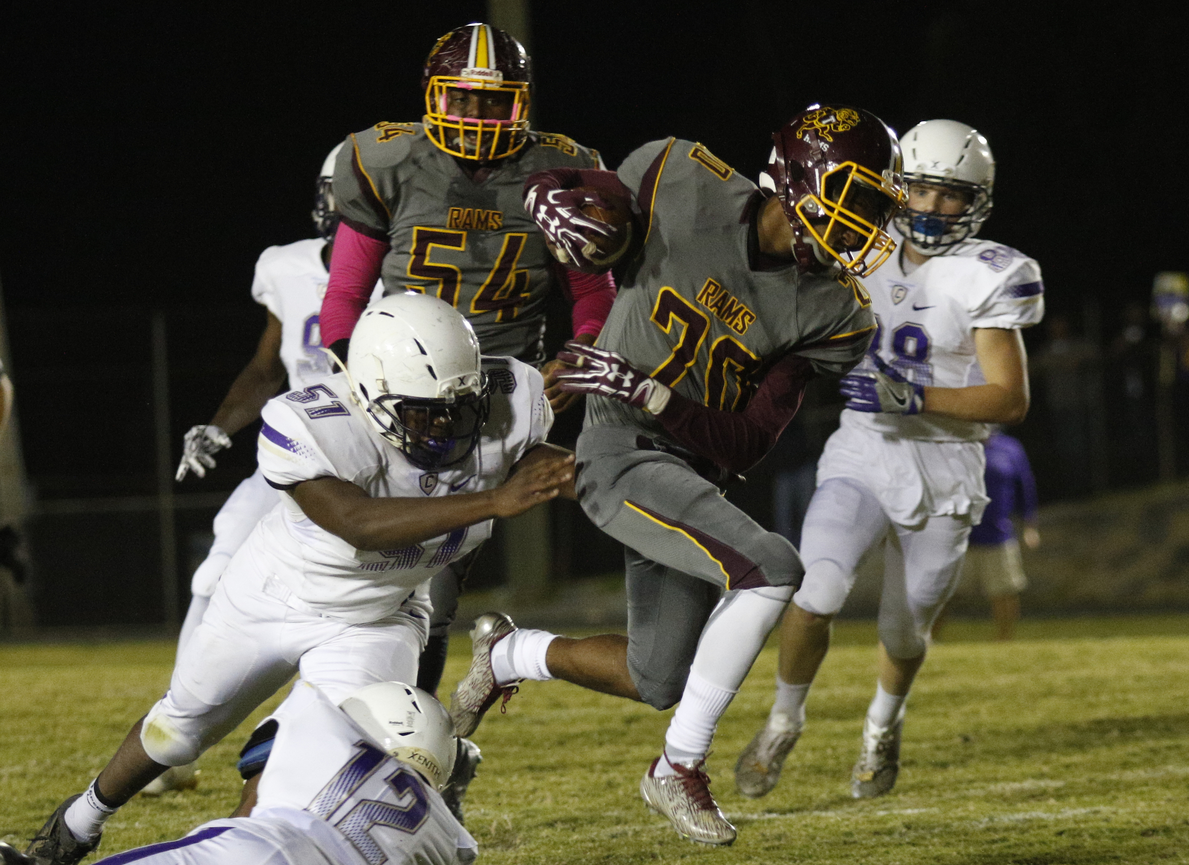 Tynerճ Jeremy Elston (20) hurdles Centralճ Tracy Odom (12) pursued by Chance Martin (51) during their prep football game at Tyner High School on Friday, Oct. 27, 2017, in Chattanooga, Tenn.