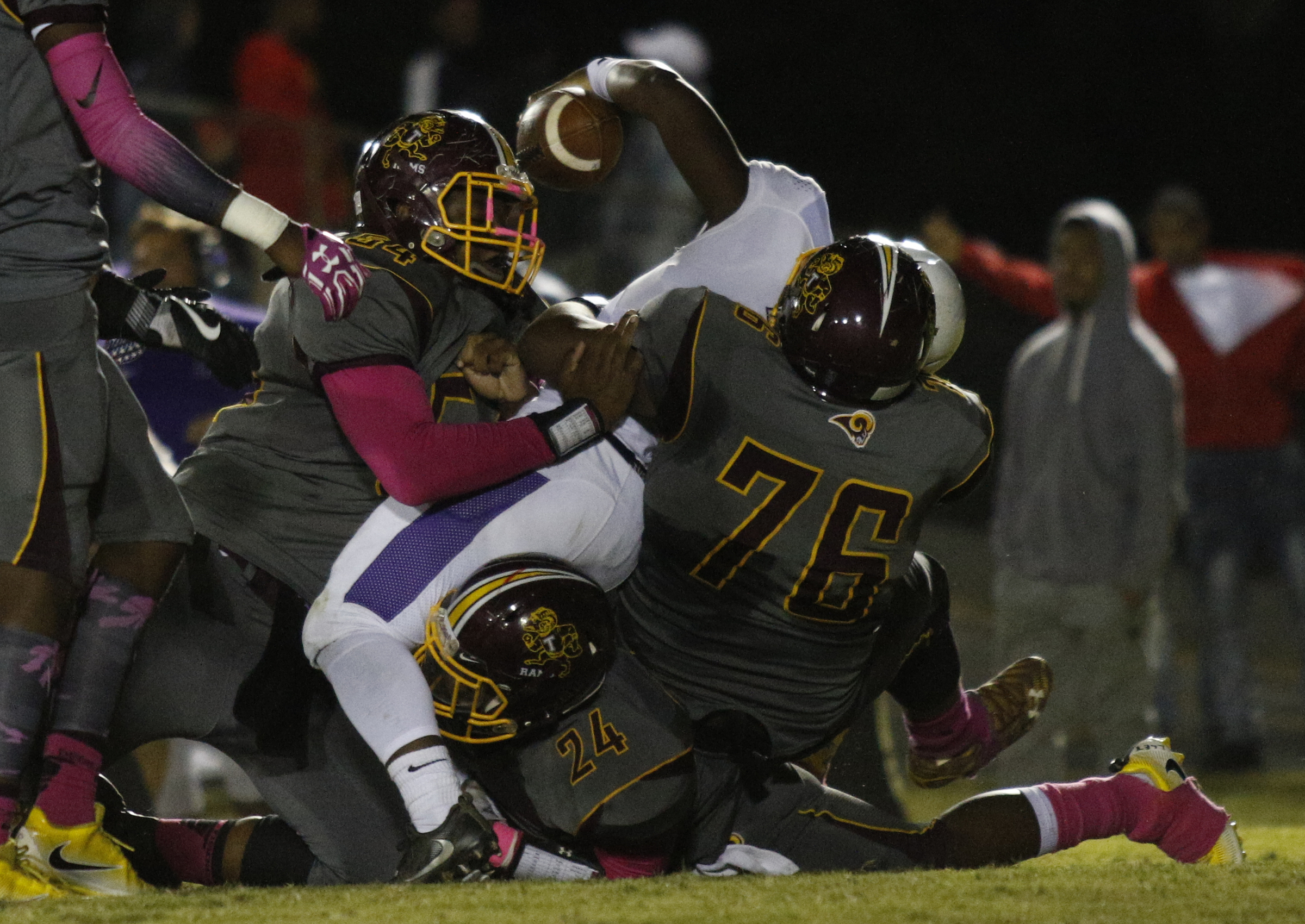 Central quarterback Jaheim Jones (7) is tackled by Tynerճ Tracy Justice (76) and Kelunta Watkins (54) during their prep football game at Tyner High School on Friday, Oct. 27, 2017, in Chattanooga, Tenn.