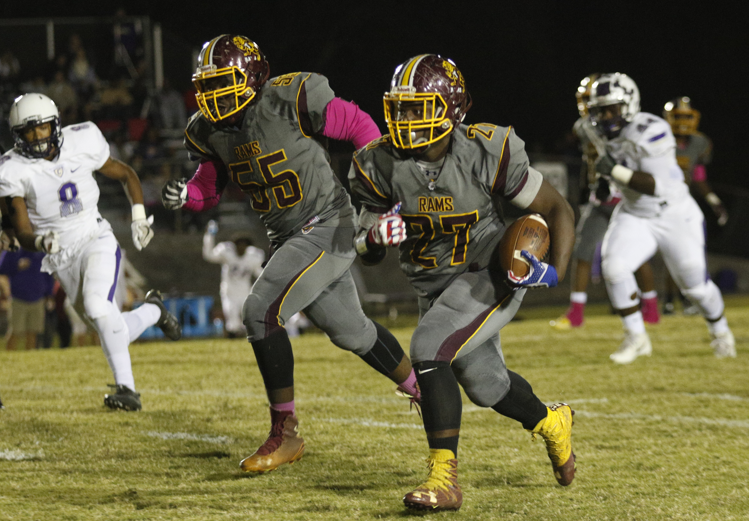 Tynerճ Tyon Young(27) takes off on a long run with backup from teammate Deandre Williams (55) during their prep football game at Tyner High School on Friday, Oct. 27, 2017, in Chattanooga, Tenn.