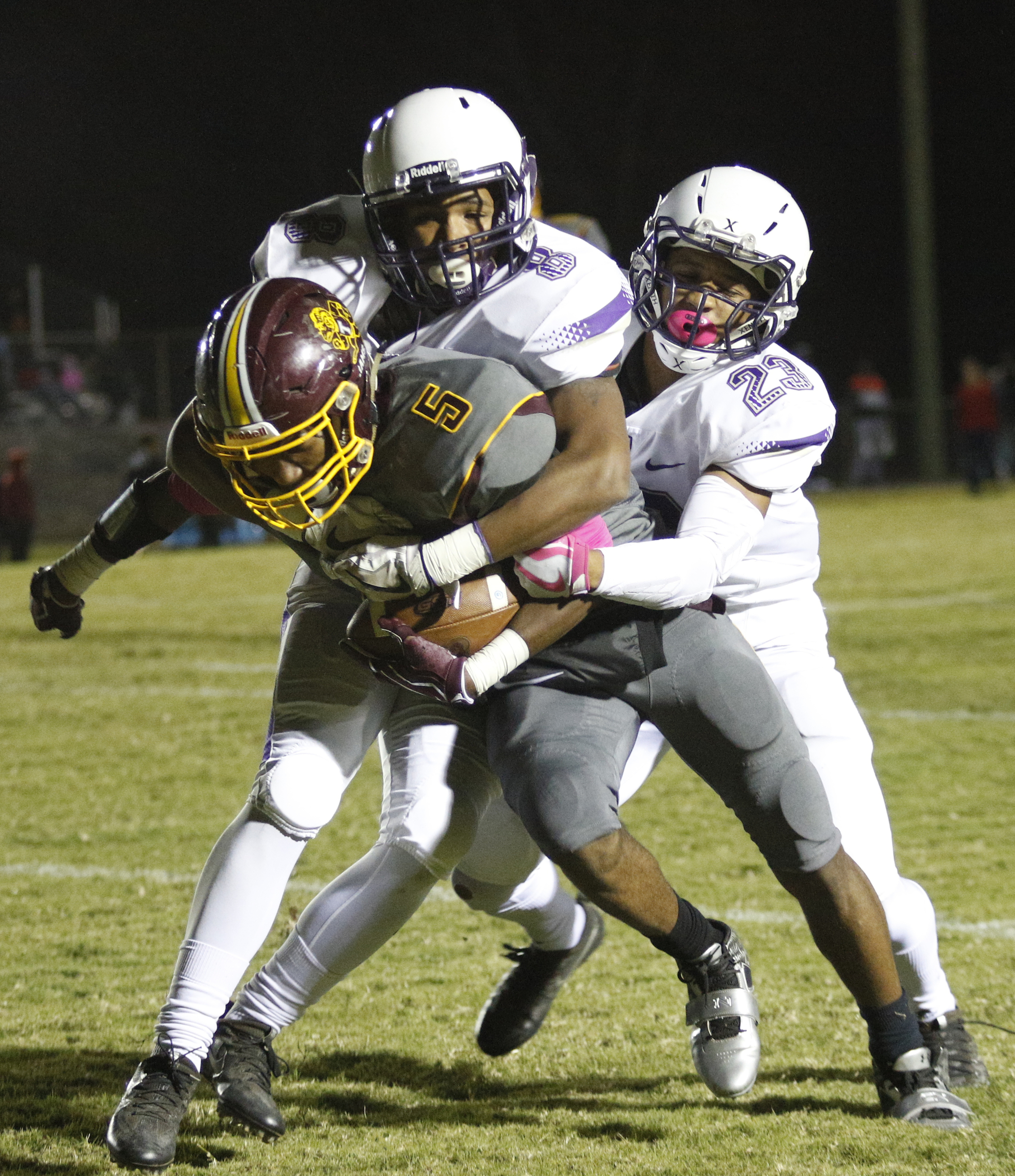 Centralճ Jaren Wilcoxson (8) and Gavin Spotts (23) tackle Tynerճ Keյn Webb (5) during their prep football game at Tyner High School on Friday, Oct. 27, 2017, in Chattanooga, Tenn.