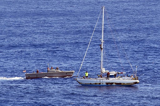 In this Wednesday, Oct. 25, 2017 photo, sailors from the USS Ashland approach a sailboat with two Honolulu women and their dogs aboard as they are rescued after being lost at sea for several months while trying to sail from Hawaii to Tahiti. The U.S. Navy rescued the women on Wednesday after a Taiwanese fishing vessel spotted them about 900 miles southeast of Japan on Tuesday and alerted the U.S. Coast Guard. The women, identified by the Navy as Jennifer Appel and Tasha Fuiaba, lost their engine in bad weather in late May, but believed they could still reach Tahiti. (Mass Communication Specialist 3rd Class Jonathan Clay/U.S. Navy via AP)