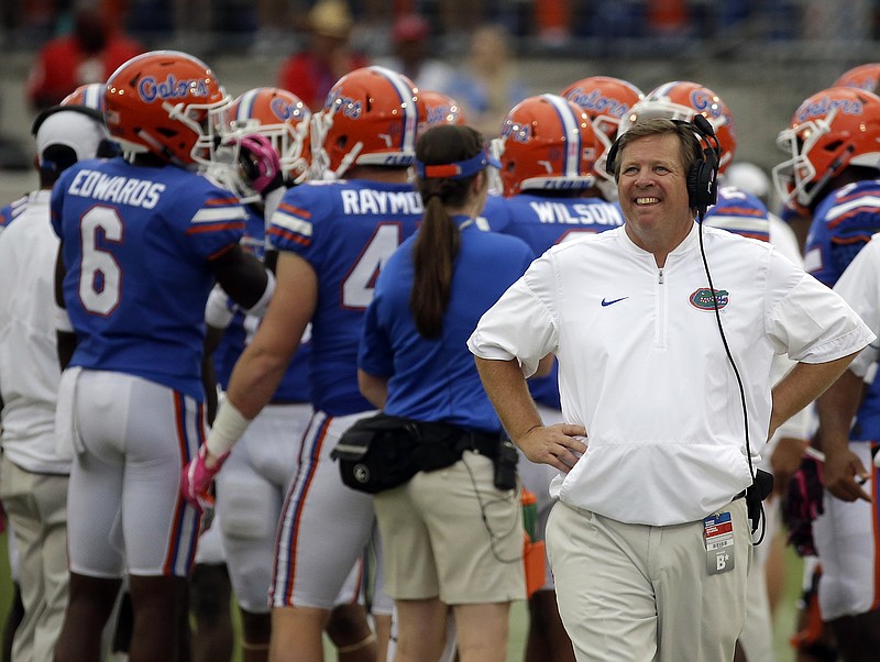 Florida football coach Jim McElwain, right, stands on the sideline during a timeout in the Gators' 42-7 loss Saturday to Georgia in Jacksonville.