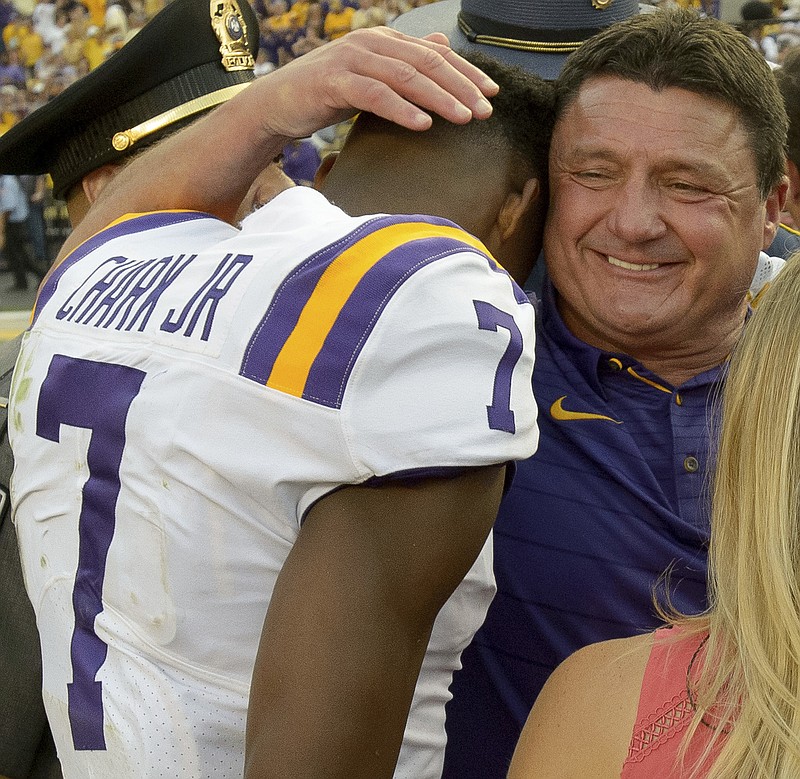 LSU football coach Ed Orgeron hugs wide receiver D.J. Chark after the team's 27-23 victory over Auburn on Oct. 14.