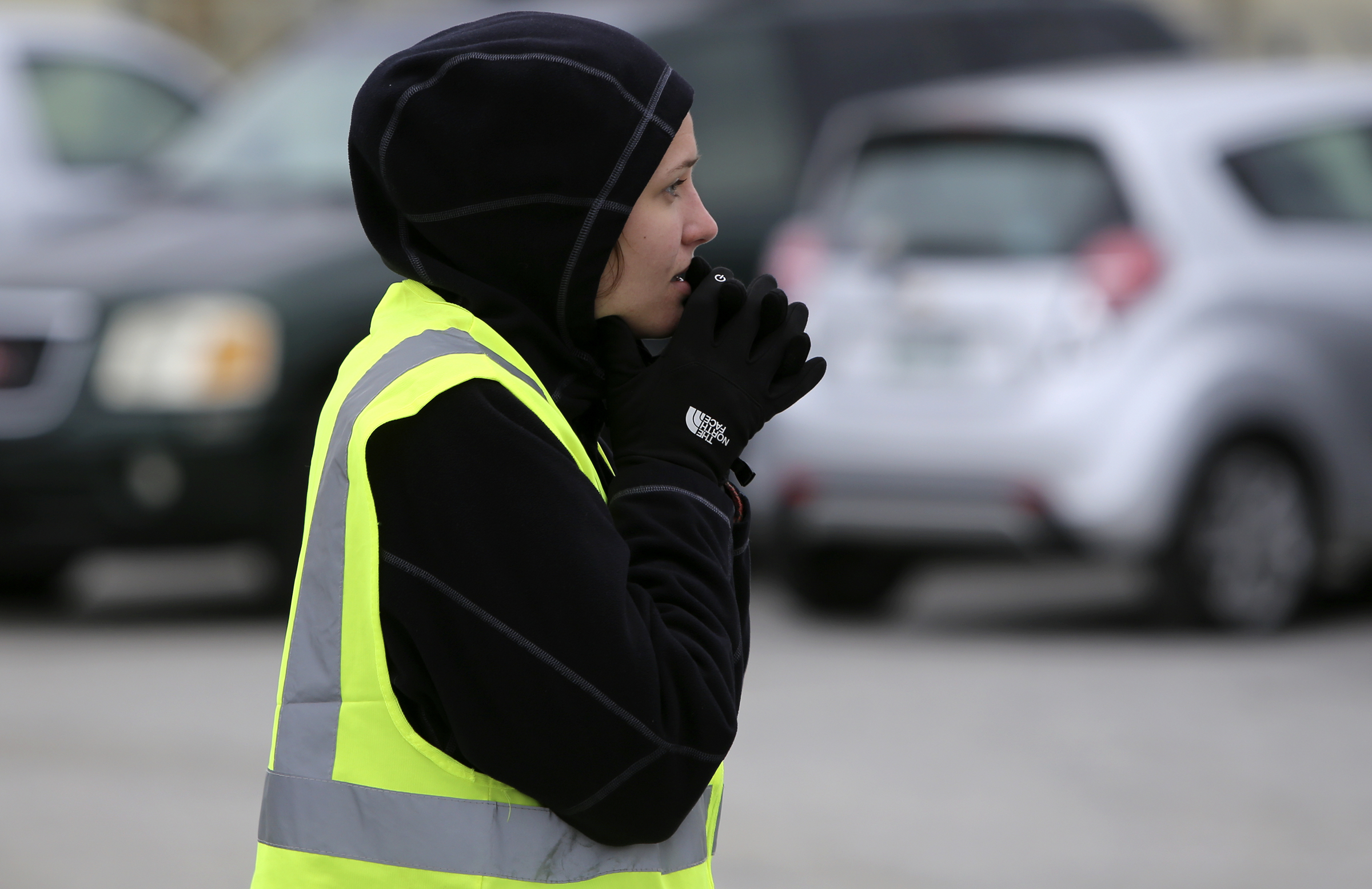 Bailey Labrenz, who was volunteering with Southern Adventist University, tries to stay warm as she helps with parking during the Glass Street Live! stop of the City Celebration and Ciclovia on Sunday, Oct. 29, 2017 in Chattanooga, Tenn. The Celebration and Civlovia was a 4-mile rolling block party with stops in five East Chattanooga neighborhoods.