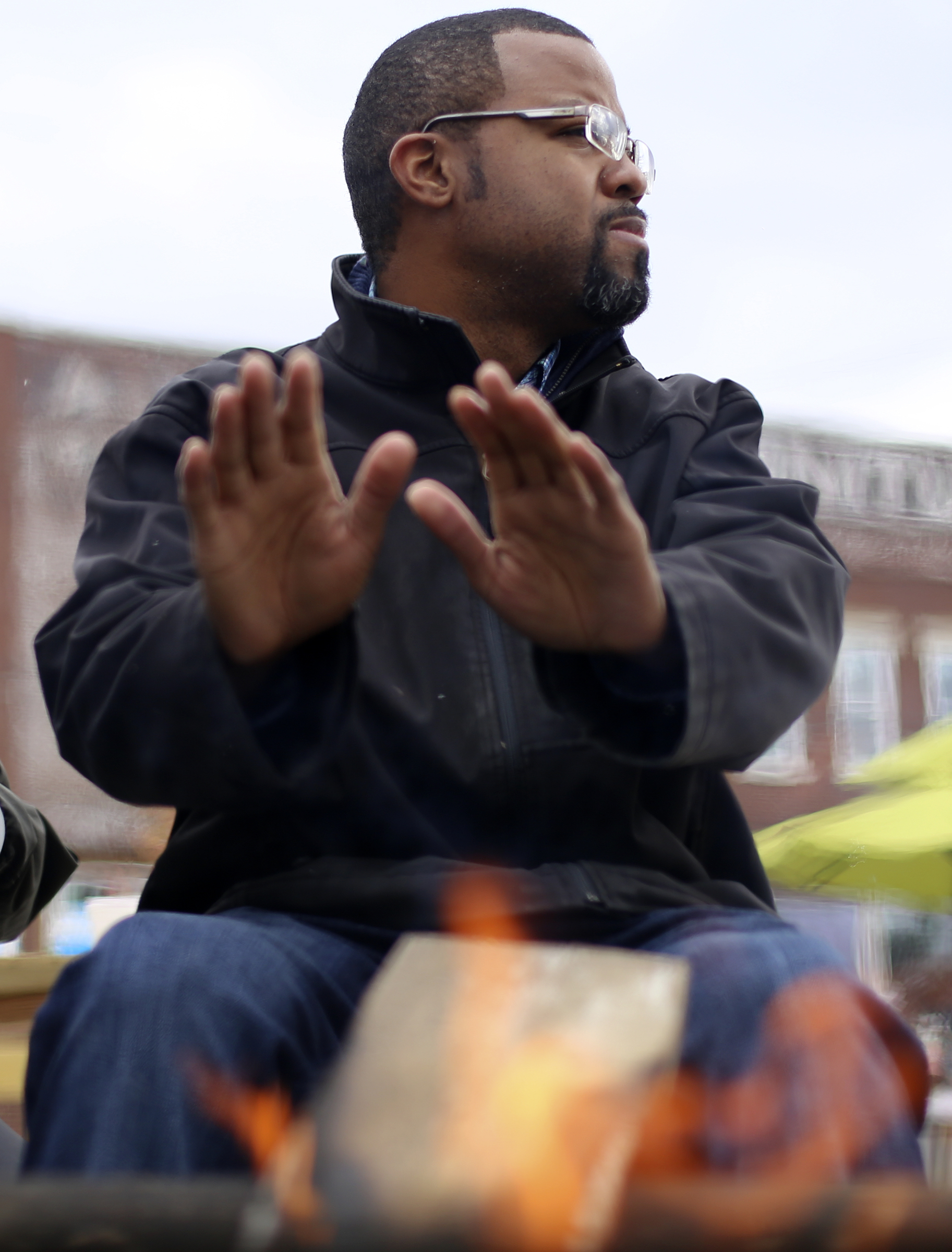 Claude Daniel warms his hands by the fire during the Glass Street Live! stop of the City Celebration and Ciclovia on Sunday, Oct. 29, 2017 in Chattanooga, Tenn. The Celebration and Civlovia was a 4-mile rolling block party with stops in five East Chattanooga neighborhoods.