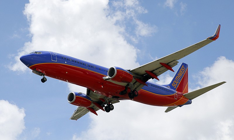 FILE - In this Aug. 26, 2016, file photo, a Southwest Airlines jet makes its approach to Dallas Love Field airport, in Dallas. Booking flights can be stressful as consumers worry about how to get the best deal and how far ahead to book, especially at holiday time. Experts say check multiple websites for prices and forget the notion that there's a magic day of the week or time of day when fares drop.(AP Photo/Tony Gutierrez, File)