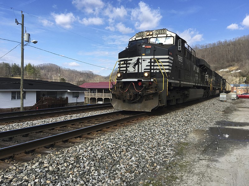 FILE - In this Feb. 16, 2017 file photo, a Norfolk Southern coal train runs through Kermit, WV. Norfolk Southern Railway must replace millions of defective wooden railroad ties on its tracks because they're degrading faster than expected, the company said in a federal lawsuit filed in October 2017 in U.S. District Court in Alabama. Norfolk Southern Railway blames an Alabama company that produced its railroad ties of failing to use proper protective coating on more than 4.7 million of them. (AP Photo/Michael Virtanen, File)