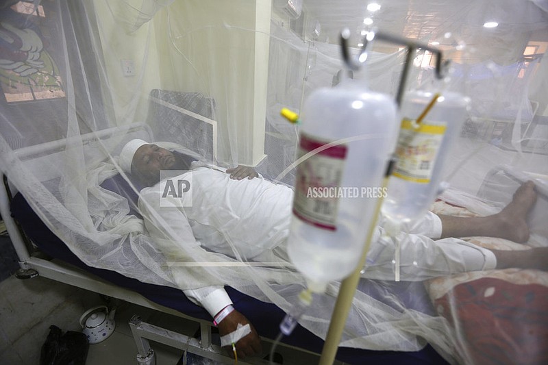 In this Thursday, Oct. 19, 2017 file photo, a patient suffering from dengue fever lies in a hospital bed in Peshawar, Pakistan. Cases of dengue fever _ a painful mosquito-borne spread disease _ have doubled every decade since 1990 with 58.4 million cases and 10,000 deaths in 2013. Dr. Howard Frumkin, a former environmental health director at the U.S. Centers for Disease Control and Prevention, said climate change, which allows mosquitoes to live in more places and stay active longer with shorter freeze seasons, is part but not all of the reason. (AP Photo/Muhammad Sajjad)