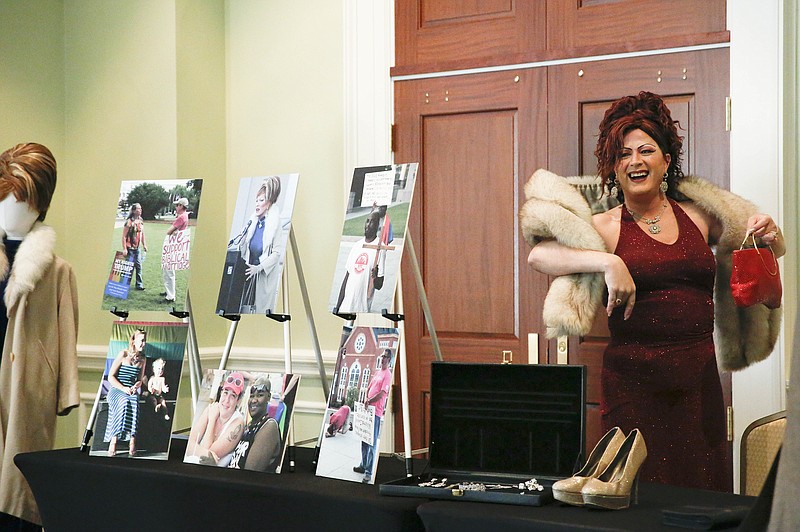 Ambrosia Starling stands up to speaks during a press conference at the Alabama Department of Archives and History after donating an array of materials associated with the marriage equality campaign, Monday, Oct. 30, 2017, in Montgomery, Ala. Artifacts include clothing worn by Starling, a marriage equality advocate and self-described drag queen, at a January 2016 rally at the Alabama Supreme Court building. The rally drew national attention during public debate over same-sex marriage and Chief Justice Roy Moore's instructions that probate judges should continue enforcing a state ban on same-sex marriage after a federal court ruling, upheld by the U.S. Supreme Court, declared the law unconstitutional. (AP Photo/Brynn Anderson)