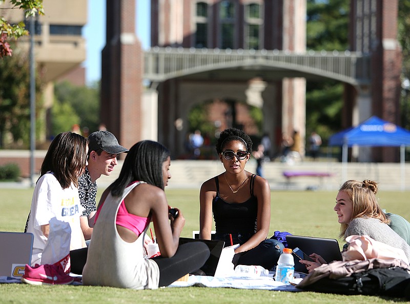 University of Tennessee at Chattanooga students Rhiannon Ong-Halleron, Sammy Mai, Brittany Johnson, Eliana Harris and Allison Mason eat and work on school work at Chamberlain Field at UTC on Tuesday, Oct. 31, 2017 in Chattanooga, Tenn. Neither the University of Tennessee at Chattanooga nor UT-Knoxville will participate in the outsourcing to a for-profit company of its campus facilities. 
