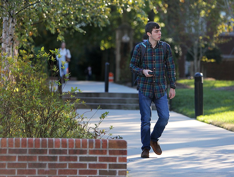 Chattanooga State nursing student Dustin Snell walks across the University of Tennessee at Chattanooga campus on Tuesday, Oct. 31, 2017 in Chattanooga, Tenn. Neither the University of Tennessee at Chattanooga nor UT-Knoxville will participate in the outsourcing to a for-profit company of its campus facilities. 