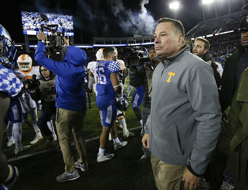 Tennessee head coach Butch Jones walks on the field after his team was defeated by Kentucky 29-26 in an NCAA college football game Saturday, Oct. 28, 2017, in Lexington, Ky. (AP Photo/David Stephenson)