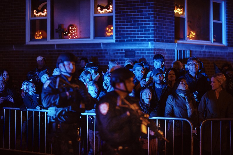 Heavily armed police guard as people watch during the Greenwich Village Halloween Parade, Tuesday, Oct. 31, 2017, in New York. (AP Photo/Andres Kudacki)