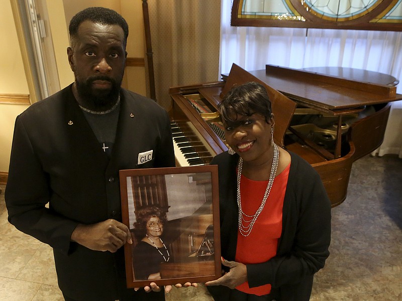 Della Chislom, right, and her brother Glenn L. Chislom pose with a photo of their mother, Deloria Westfield, at Ridgedale Baptist Church on Thursday, Oct. 26, 2017 in Chattanooga, Tenn. They are launching a scholarship fund in their mother's name.