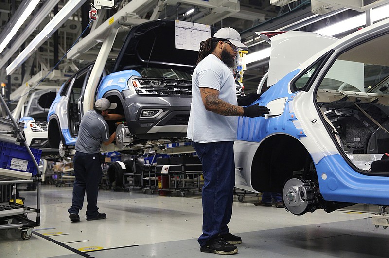 Volkswagen employees work around vehicles moving down the assembly line at the Volkswagen Plant Thursday, Aug. 31, 2017, in Chattanooga, Tenn. 