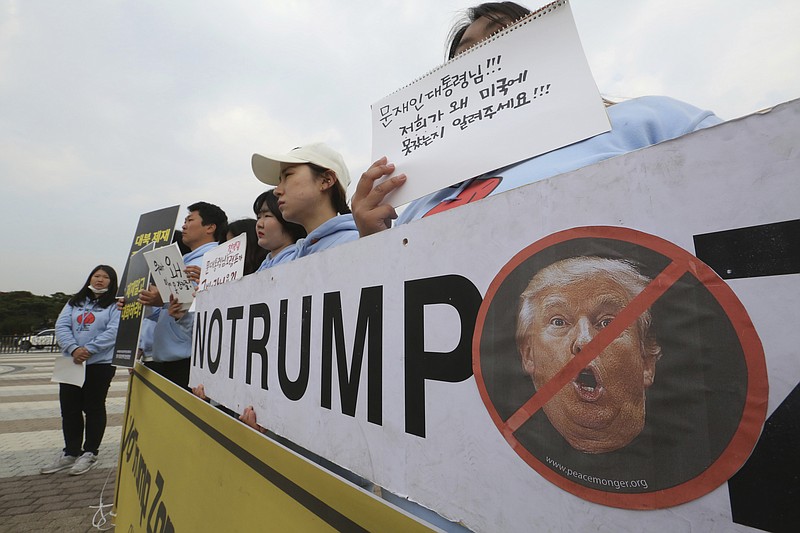 South Korean protesters stage a rally against a planned visit by the U.S. President Donald Trump, near the presidential Blue House in Seoul, South Korea, Wednesday, Nov. 1, 2017. Trump will arrive in South Korea on Nov. 7 for a two-day visit to hold a summit with South Korean President Moon Jae-in. The signs read " We oppose Trump's visit." (AP Photo/Ahn Young-joon)