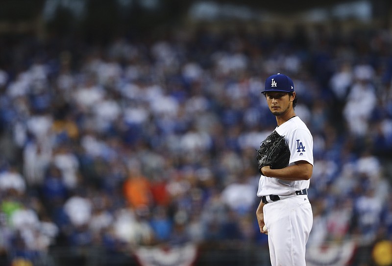 Los Angeles Dodgers starting pitcher Yu Darvish throws during the first inning of Game 7 of baseball's World Series against the Houston Astros Wednesday, Nov. 1, 2017, in Los Angeles. (AP Photo/Tim Bradbury, Pool)