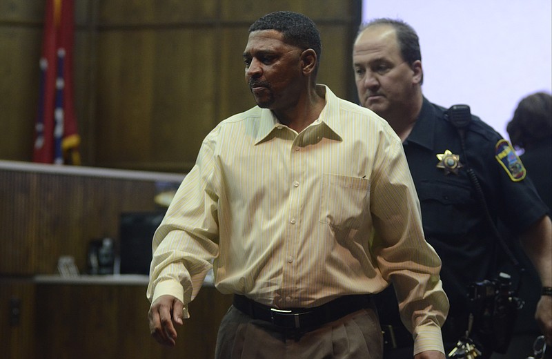 Accompanied by court officer Tim Higgs, right, defendant Tony Bigoms enters Judge Barry Steelman's courtroom Wednesday, April 9, 2014, during the first day of testimony in his murder trial. Bigoms is accused in the 2012 slaying of Dana Wilkes.