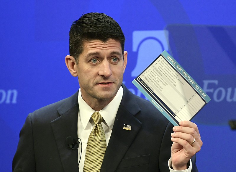 House Speaker Paul Ryan, R-Wis., holds up a copy of a proposed "simple tax" postcard earlier this month while speaking at the Heritage Foundation in Washington, D.C.