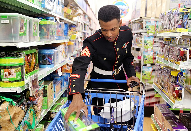 Cpl. Willie Sparks puts items in his cart for boys age 3 to 5 years old during a Toys for Tots purchasing event Thursday, Nov. 2, 2017 at Toys "R" Us in Chattanooga, Tenn. U.S. Marine Corps Reserve Toys for Tots Program was started in 1947 with 5,000 toys collected for less fortunate children around Christmastime, and now the program has grown to distributing over 16 million toys each year.
