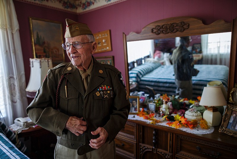 Thomas Rollins puts on his Army uniform in the bedroom of his home on Thursday, Oct. 26, 2017, in Altamont, Tenn. Rollins gave away his original Eisenhower jacket to a man in need during cold weather in Chicago, but a stranger he met during a Labor Day re-enactment in Fort Oglethorpe, Ga., sent him a replacement. Rollins is a veteran of the United States Army who served with the 28th Infantry Division in the European theater during World War II. He was drafted in 1944 and served until 1946 before enlisting an additional 3 years in the Army Reserves.