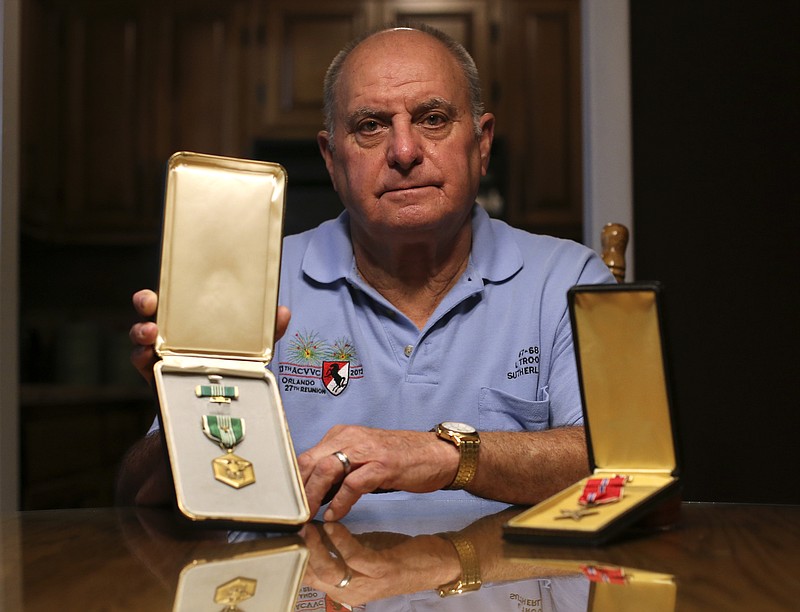 Harland J. Sutherland Jr. poses with his Army Commendation Medal with "V" device, left, and Bronze Star Medal at his home on Monday, Oct. 30, 2017 in Soddy-Daisy, Tenn. Sutherland served in the U.S. Army during the Vietnam War.
