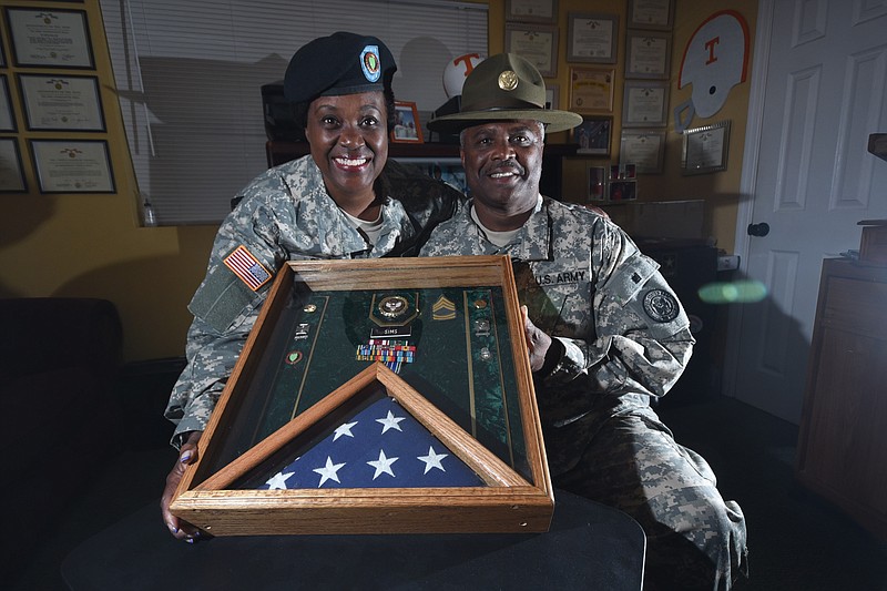 SFC Azelia Sims, left, and her husband, SFC Noble Sims retired from the Army after more than 20 years service, each. Noble Sims wears his drill sergeant hat from his four years at Ft. Jackson, S.C. Both retired from the Army.