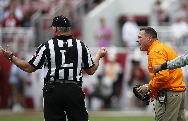 Tennessee head coach Butch Jones disagrees with the referee about a play during the first half an NCAA college football game Alabama, Saturday, Oct. 21, 2017, in Tuscaloosa, Ala. (AP Photo/Brynn Anderson)