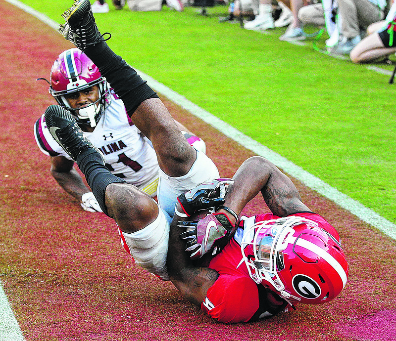 Georgia's Mecole Hardman catches a touchdown pass past South Carolina defender Jamyest Williams during the third quarter of an NCAA college football game Saturday, Nov. 4, 2017, in Athens, Ga. (Curtis Compton/Atlanta Journal Constitution via AP)