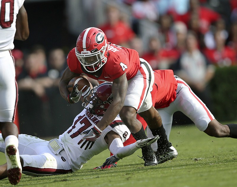 Georgia wide receiver Mecole Hardman (4) is brought down by South Carolina defensive back Javon Charleston (17) during the first half of an NCAA college football game Saturday, Nov. 4, 2017, in Athens, Ga. (AP Photo/John Bazemore)