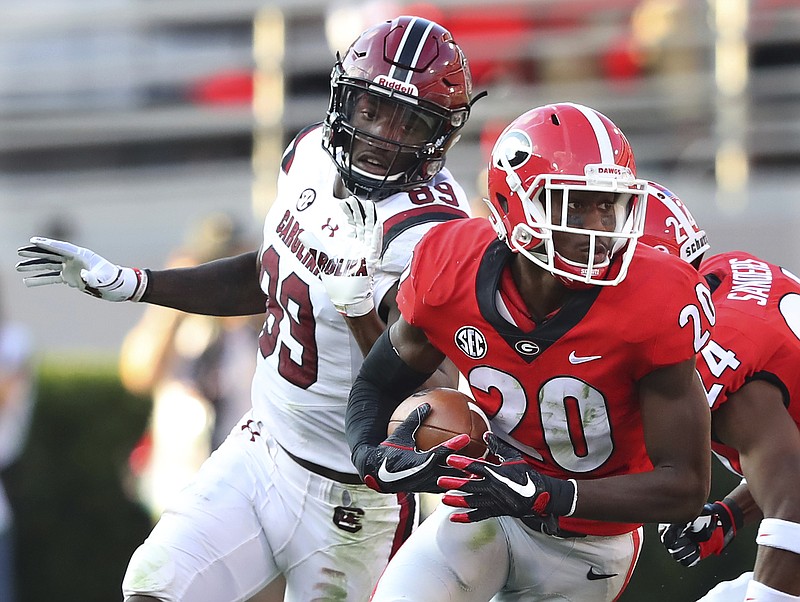 Georgia defensive back J.R. Reed intercepts a South Carolina pass in front of wide receiver Bryan Edwards during the second quarter during an NCAA college football game Saturday, Nov. 4, 2017, in Athens, Ga. (Curtis Compton/Atlanta Journal Constitution via AP)