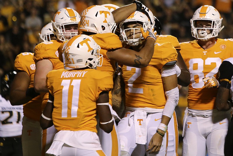 Teammates congratulate Tennessee quarterback Jarrett Guarantano (2) after his rushing touchdown on the Vols' first possession Saturday against Southern Miss.