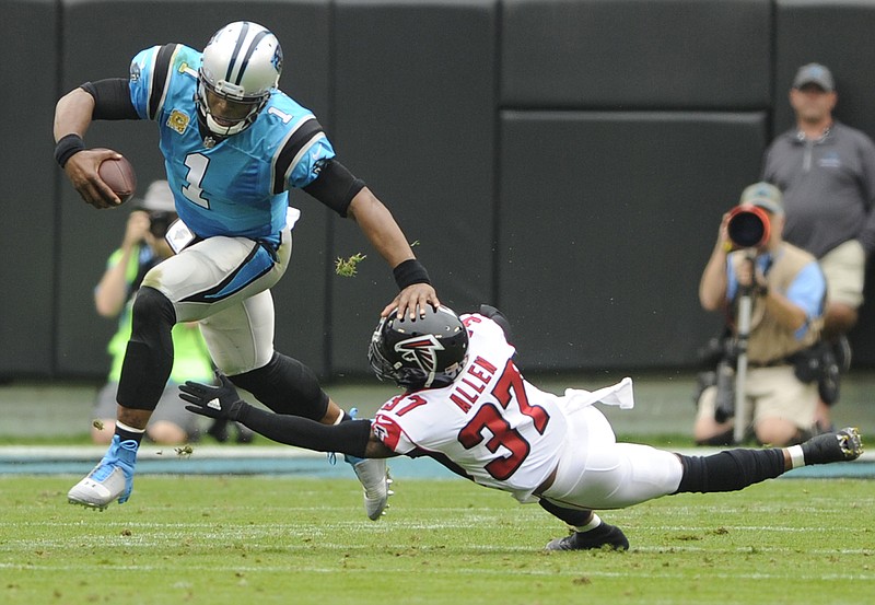 Carolina Panthers' Cam Newton (1) runs past Atlanta Falcons' Ricardo Allen (37) in the first half of an NFL football game in Charlotte, N.C., Sunday, Nov. 5, 2017. (AP Photo/Mike McCarn)