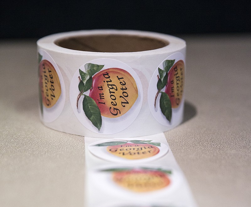 Georgia voter stickers are set up for voters to take on election day at the Rossville Civic Center on Tuesday, Nov. 8, 2016, in Rossville, Ga.