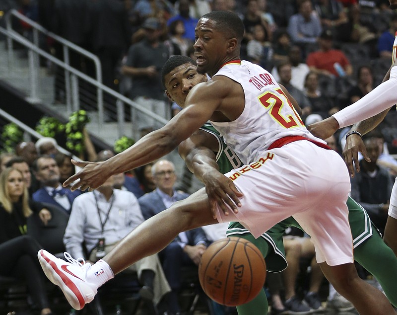 Boston Celtics guard Marcus Smart (36) passes around Atlanta Hawks guard Isaiah Taylor (22) during the first half of an NBA basketball game Monday, Nov. 6, 2017, in Atlanta. (AP Photo/John Bazemore)