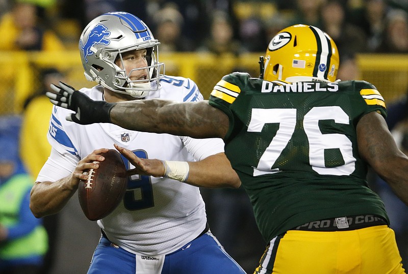 Detroit Lions' Matthew Stafford drops back with Green Bay Packers' Mike Daniels rushing during the first half of an NFL football game Monday, Nov. 6, 2017, in Green Bay, Wis. (AP Photo/Mike Roemer)