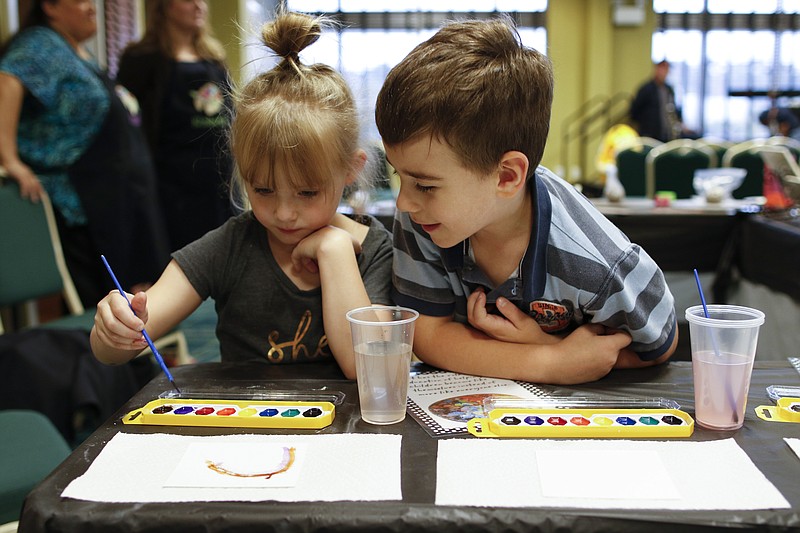 Barrett Swanson watches Bella York watercolor, an example of the kinds of opportunities students at Alpine Crest Elementary will now have thanks to SpringHill Suites' outreach. (Staff photo by Doug Strickland)