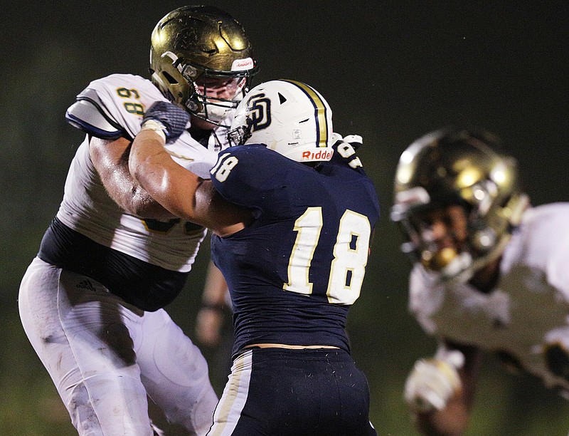 Knoxville Catholic's Cade Mays (68) puts up a block against Soddy-Daisy's Jake Seeger (18) during the Soddy-Daisy vs. Knoxville Catholic game at Soddy-Daisy High School in Soddy-Daisy, Tenn., Friday, Sept. 15, 2017.