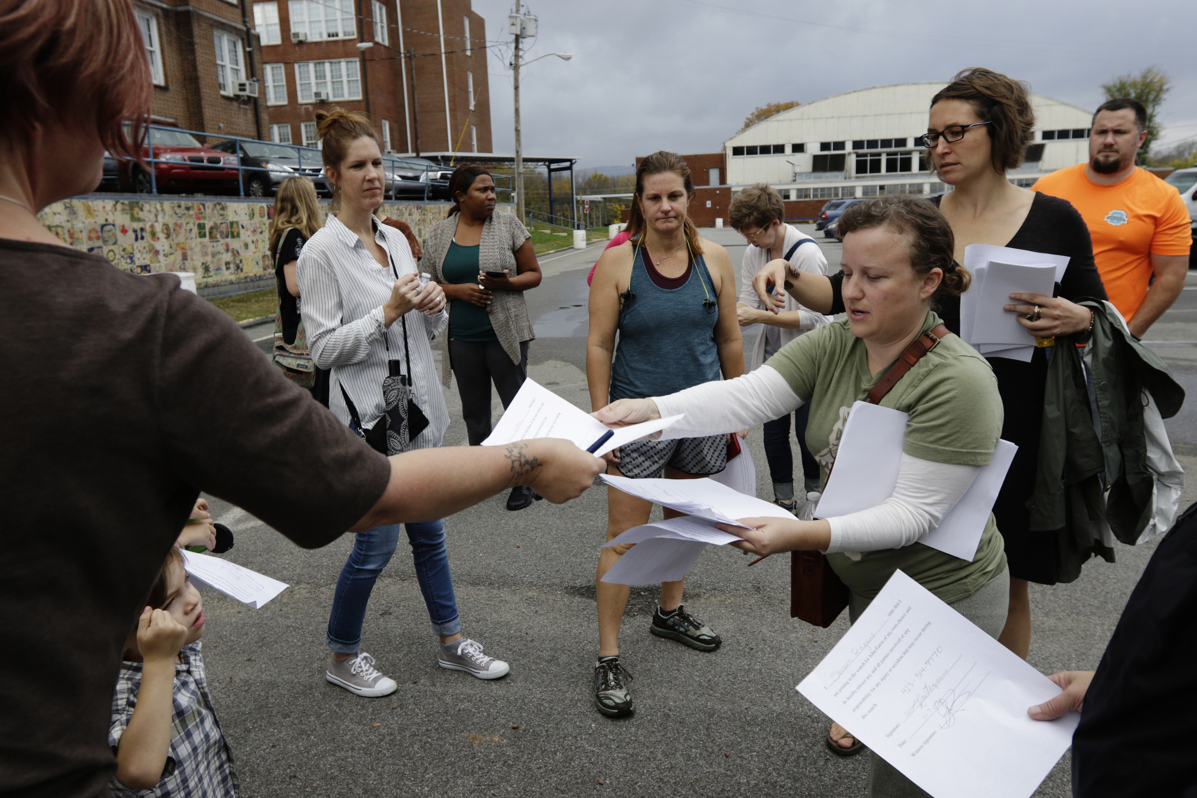 Volunteers prepare to set out on a search for missing CSAS 2nd grade teacher John Eaton from the school's parking lot on Tuesday, Nov. 7, 2017, in Chattanooga, Tenn. Volunteers searched Eaton's typical route from Sequoyah Access Road along U.S. Highway 27, Tennessee Highway 153, DuPont Parkway, and Amnicola Highway to the school. Eaton left home on Sunday for the school but never returned.