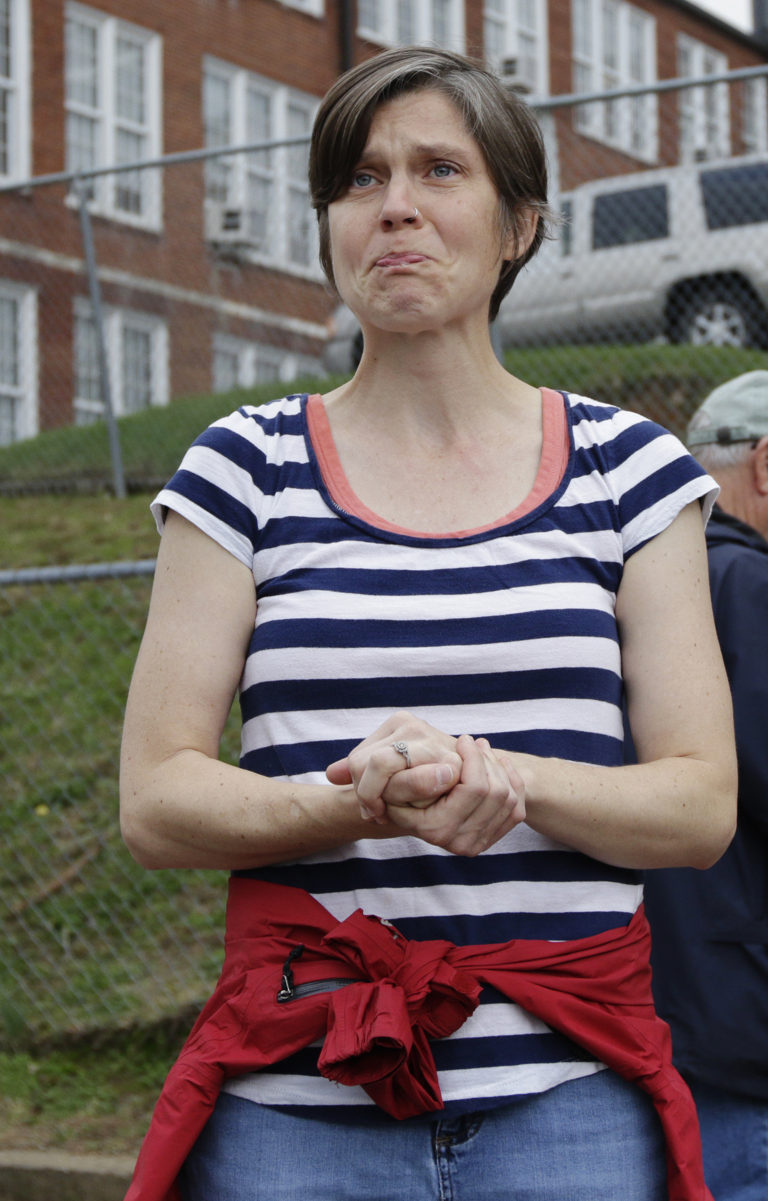 Missing CSAS 2nd grade teacher John Eaton's wife Melissa speaks in the school parking lot before volunteers set out on a search for her husband on Tuesday, Nov. 7, 2017, in Chattanooga, Tenn. Volunteers searched Eaton's typical route from Sequoyah Access Road along U.S. Highway 27, Tennessee Highway 153, DuPont Parkway, and Amnicola Highway to the school. Eaton left home on Sunday for the school but never returned.