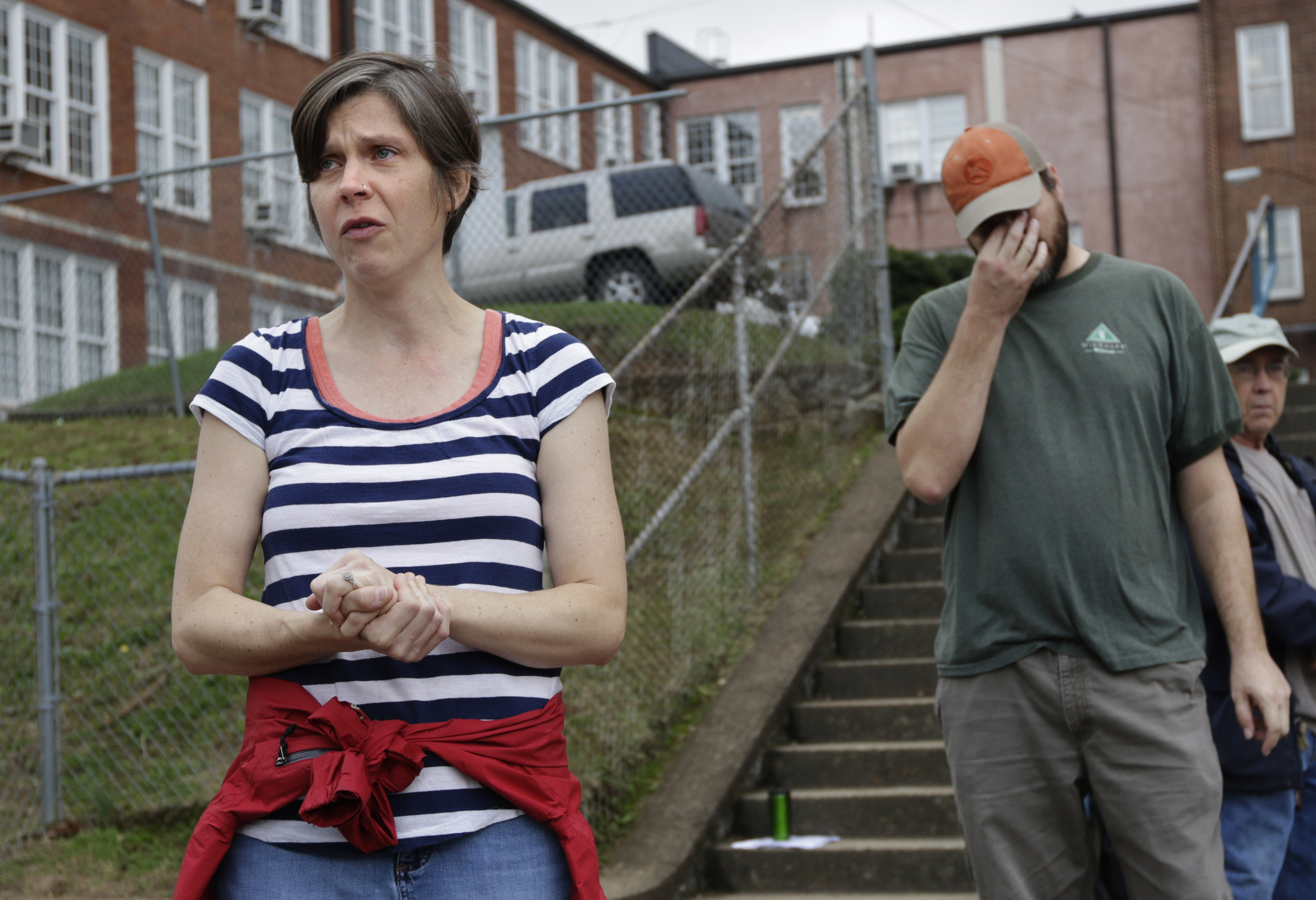 Missing CSAS 2nd grade teacher John Eaton's wife Melissa, left, speaks as Robert Parks stands nearby in the school parking lot before volunteers set out on a search for her husband on Tuesday, Nov. 7, 2017, in Chattanooga, Tenn. Volunteers searched Eaton's typical route from Sequoyah Access Road along U.S. Highway 27, Tennessee Highway 153, DuPont Parkway, and Amnicola Highway to the school. Eaton left home on Sunday for the school but never returned.