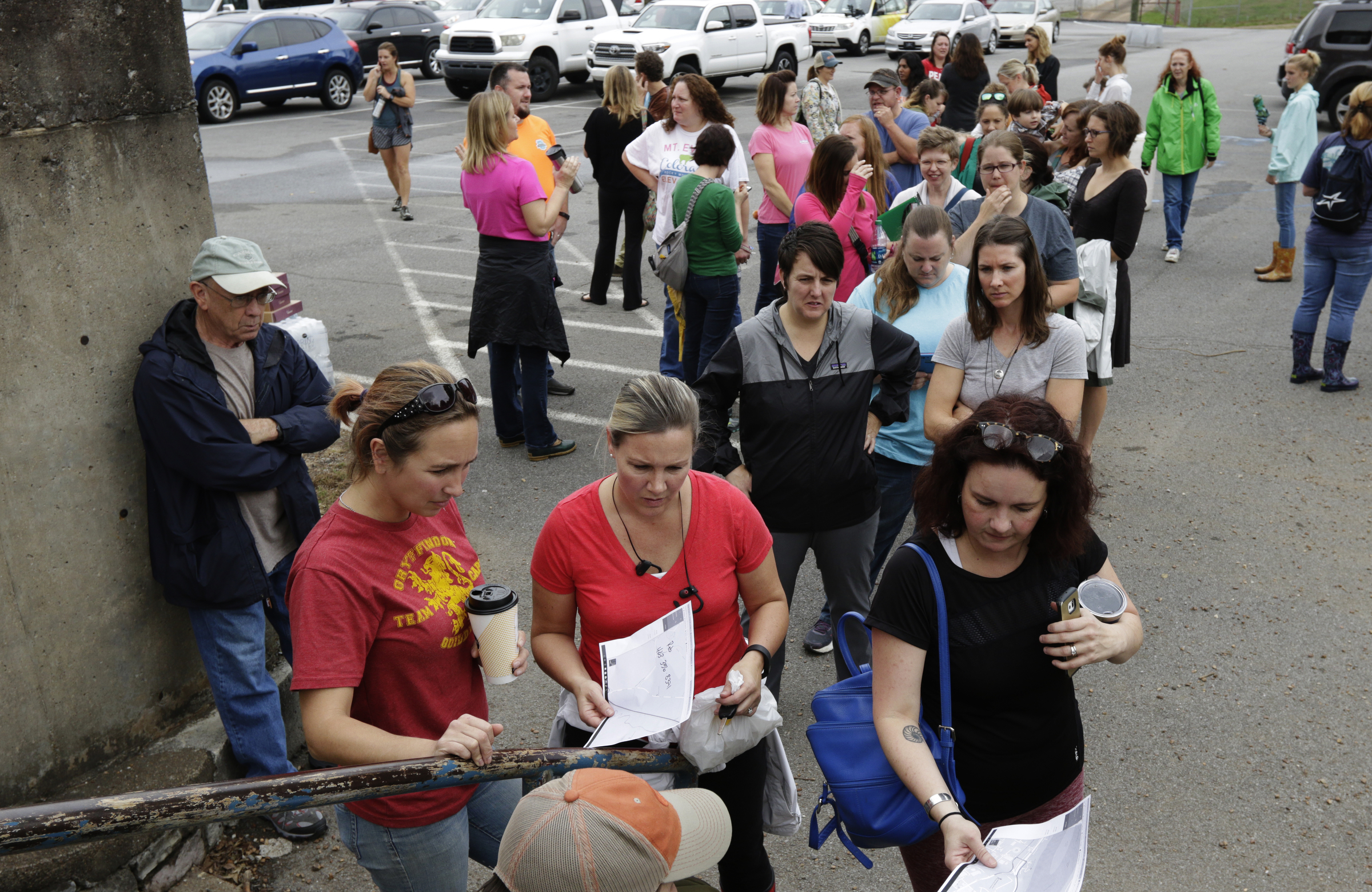 Volunteers line up to get route assignments in the CSAS parking lot in a search for missing 2nd grade teacher John Eaton on Tuesday, Nov. 7, 2017, in Chattanooga, Tenn. Eaton left home on Sunday for the school but never returned. Volunteers searched Eaton's typical route from Sequoyah Access Road along U.S. Highway 27, Tennessee Highway 153, DuPont Parkway, and Amnicola Highway to the school.