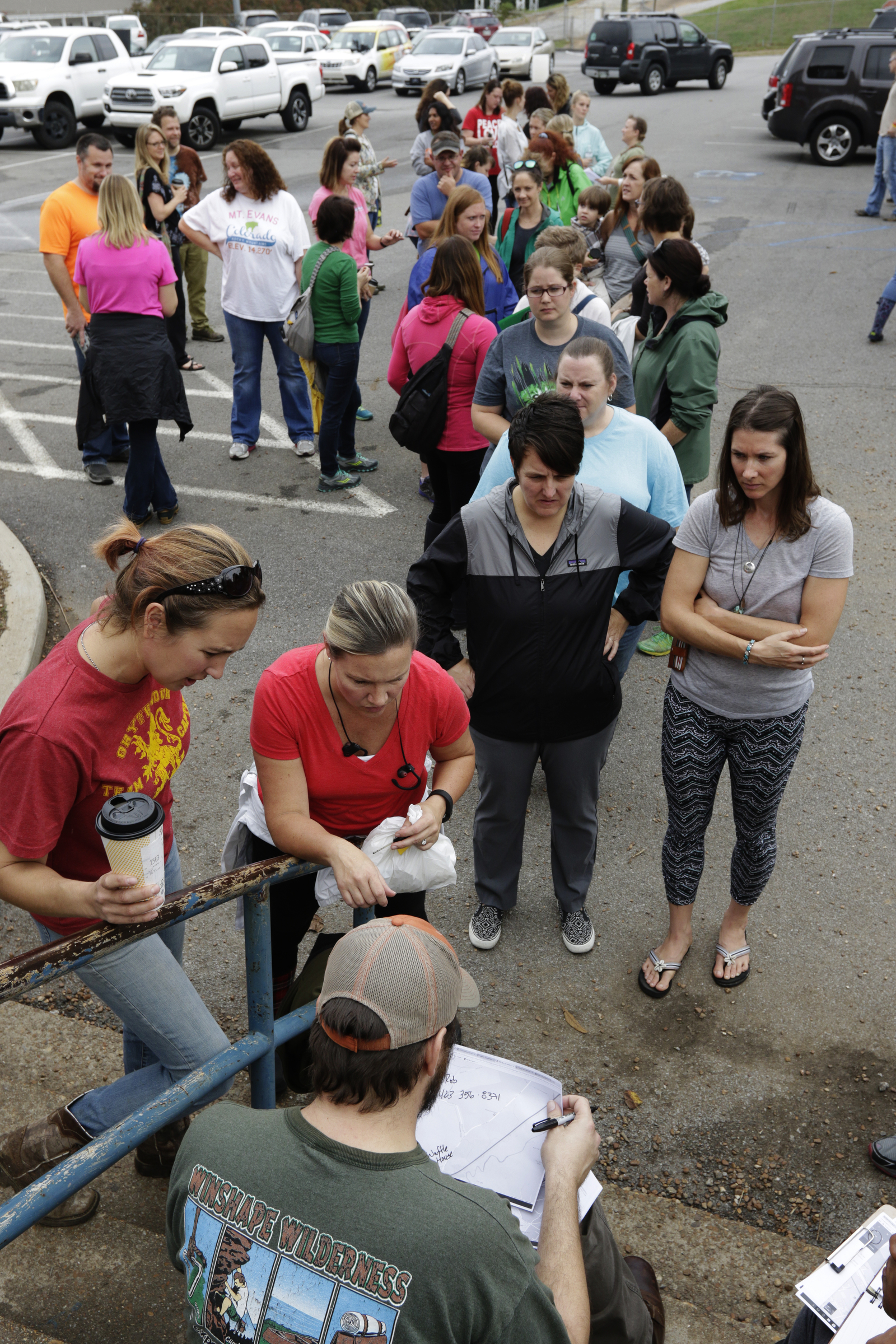 Volunteers line up to get route assignments in the CSAS parking lot in a search for missing 2nd grade teacher John Eaton on Tuesday, Nov. 7, 2017, in Chattanooga, Tenn. Eaton left home on Sunday for the school but never returned. Volunteers searched Eaton's typical route from Sequoyah Access Road along U.S. Highway 27, Tennessee Highway 153, DuPont Parkway, and Amnicola Highway to the school.