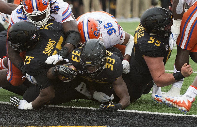 Missouri running back Larry Rountree III squeezes through the pile as he scores a touchdown during the second quarter of an NCAA college football game against Florida Saturday, Nov. 4, 2017, in Columbia, Mo. (AP Photo/L.G. Patterson)