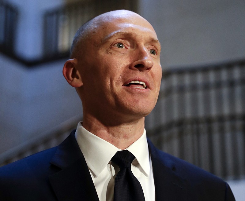 In this Nov. 2, 2017, photo, Carter Page, a foreign policy adviser to Donald Trump's 2016 presidential campaign, speaks with reporters following a day of questions from the House Intelligence Committee, on Capitol Hill in Washington. (AP Photo/J. Scott Applewhite)