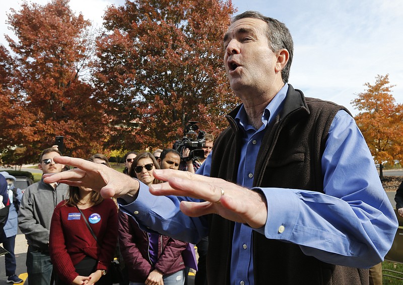 Democratic gubernatorial candidate Lt. Gov. Ralph Northam talks with volunteers at a canvass kickoff site in Sterling, Va., Saturday, Nov. 4, 2017. Northam faces Republican challenger Ed Gillespie in the Nov. 7 th election. (AP Photo/Steve Helber)